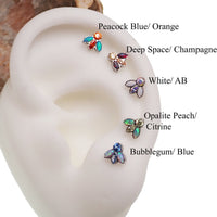 Colorful bug-shaped opal and CZ titanium top dermal body jewelry in 14g with intricate design, perfect for body piercing.