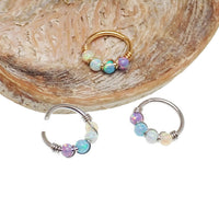 Sterling silver fire opal nose and ear hoop, 8mm diameter, from Body Clickers Body Jewelry, showcasing a vibrant gemstone in a hoop style.