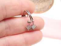 Titanium hoop earrings with charms from Body Clickers Body Jewelry, 20g, featuring sleek silver designs and decorative charms.
