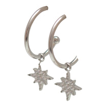 Titanium hoop earrings and charms by Body Clickers Body Jewelry, 20g, featuring sleek hoop design with decorative charms