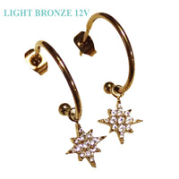 Titanium hoop earrings with charms, 20g, by Body Clickers Body Jewelry, showing sleek silver hoops with decorative charms.