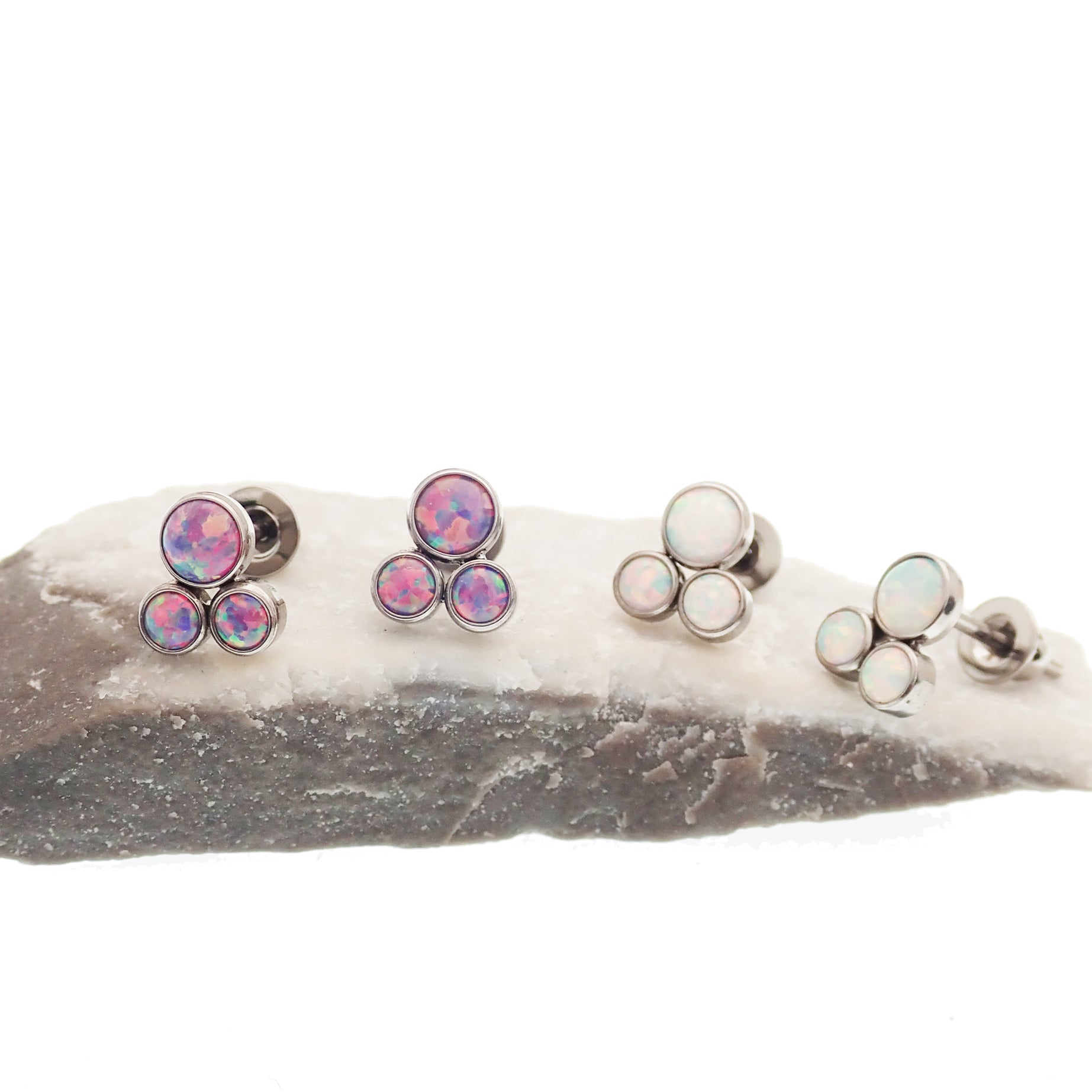 Pair of Body Clickers titanium implant earrings with white opal Trinity Fire design, 20g gauge, suitable for pierced ears.