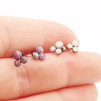Pair of Body Clickers Titanium Trinity Fire Opal earrings with white opal accents, 20g implant-grade jewelry for pierced ears.
