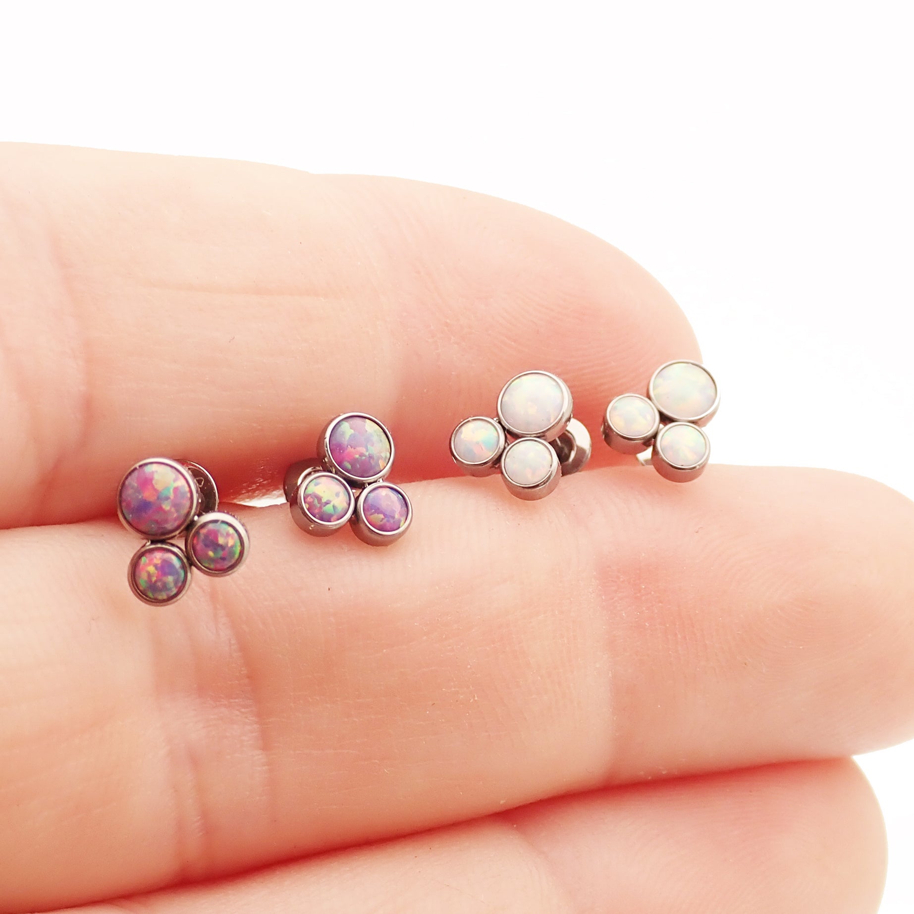 Pair of Body Clickers Titanium Trinity Fire Opal earrings with white opal accents, 20g implant-grade jewelry for pierced ears.