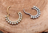 White opal and clear CZ titanium clicker earring in 16g size with 8mm diameter, featuring a sleek, modern design.