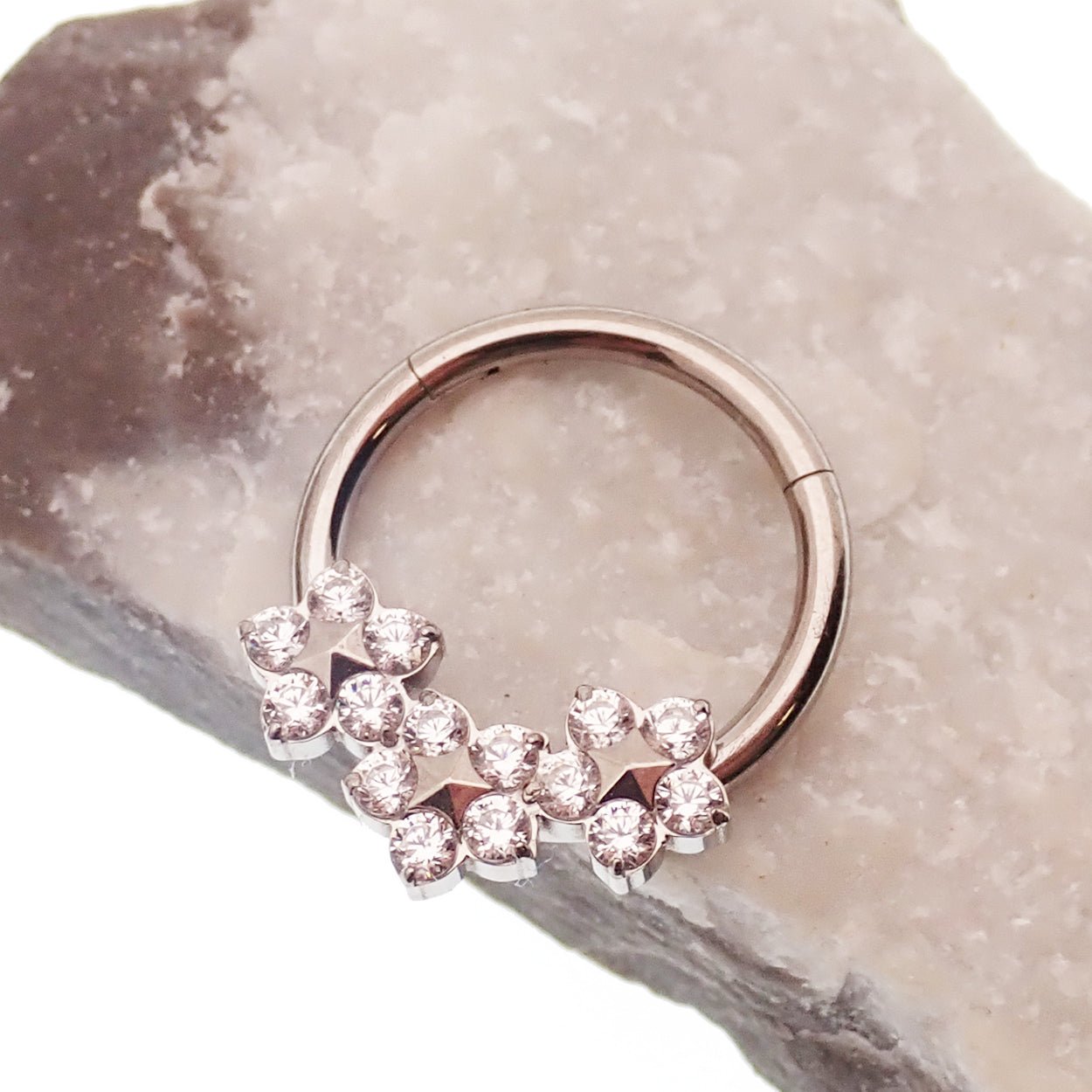 Flower titanium hinged clicker earring in 10mm size, 16 gauge, with intricate floral design from Body Clickers.