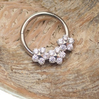 Flower titanium hinged 10mm clicker earrings in 16g from Body Clickers, showing the jewelry's floral design and sleek metal finish.