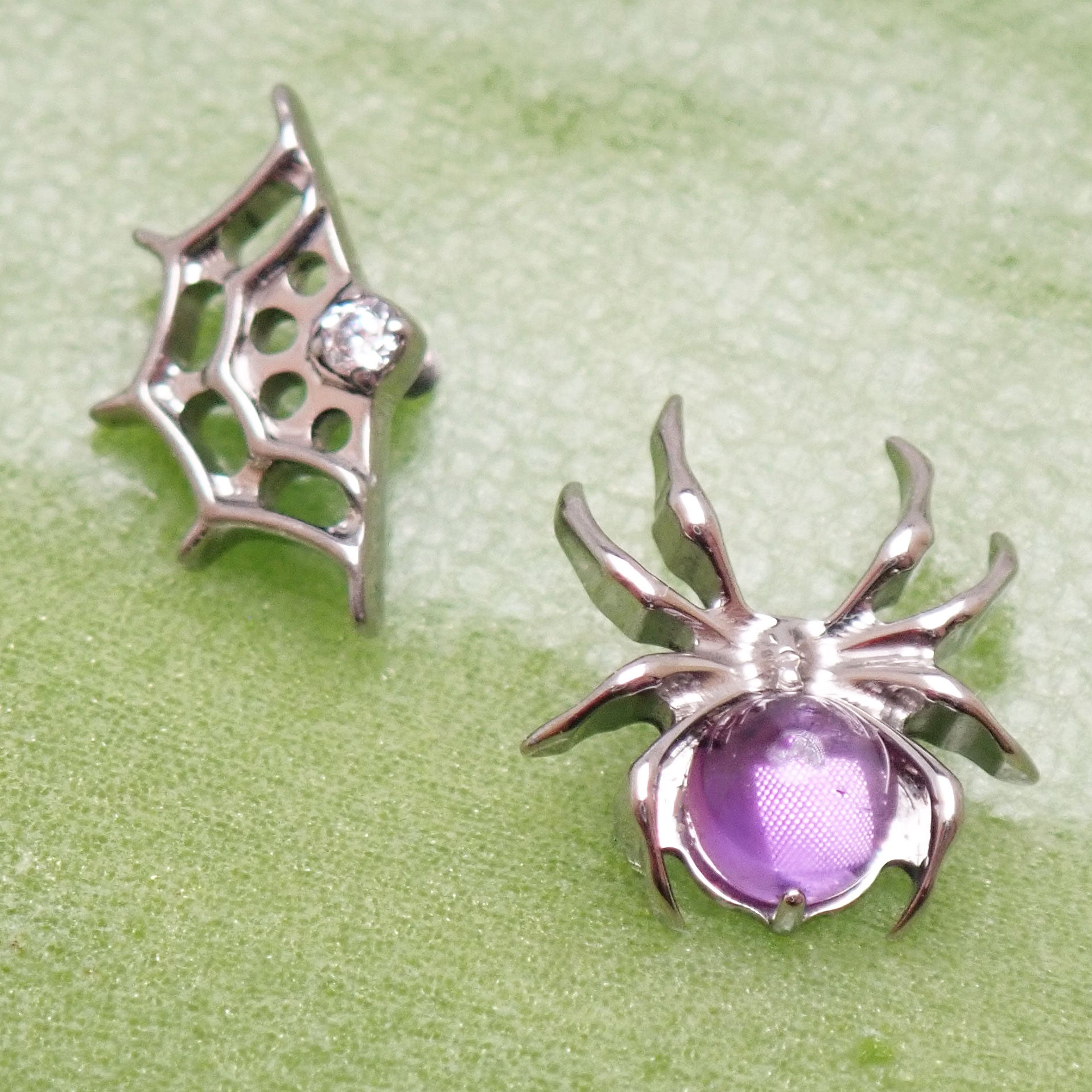 Internally threaded titanium Amethyst Spider & Web flatback earring by Body Clickers, 18g, 6mm, with purple gemstone design.