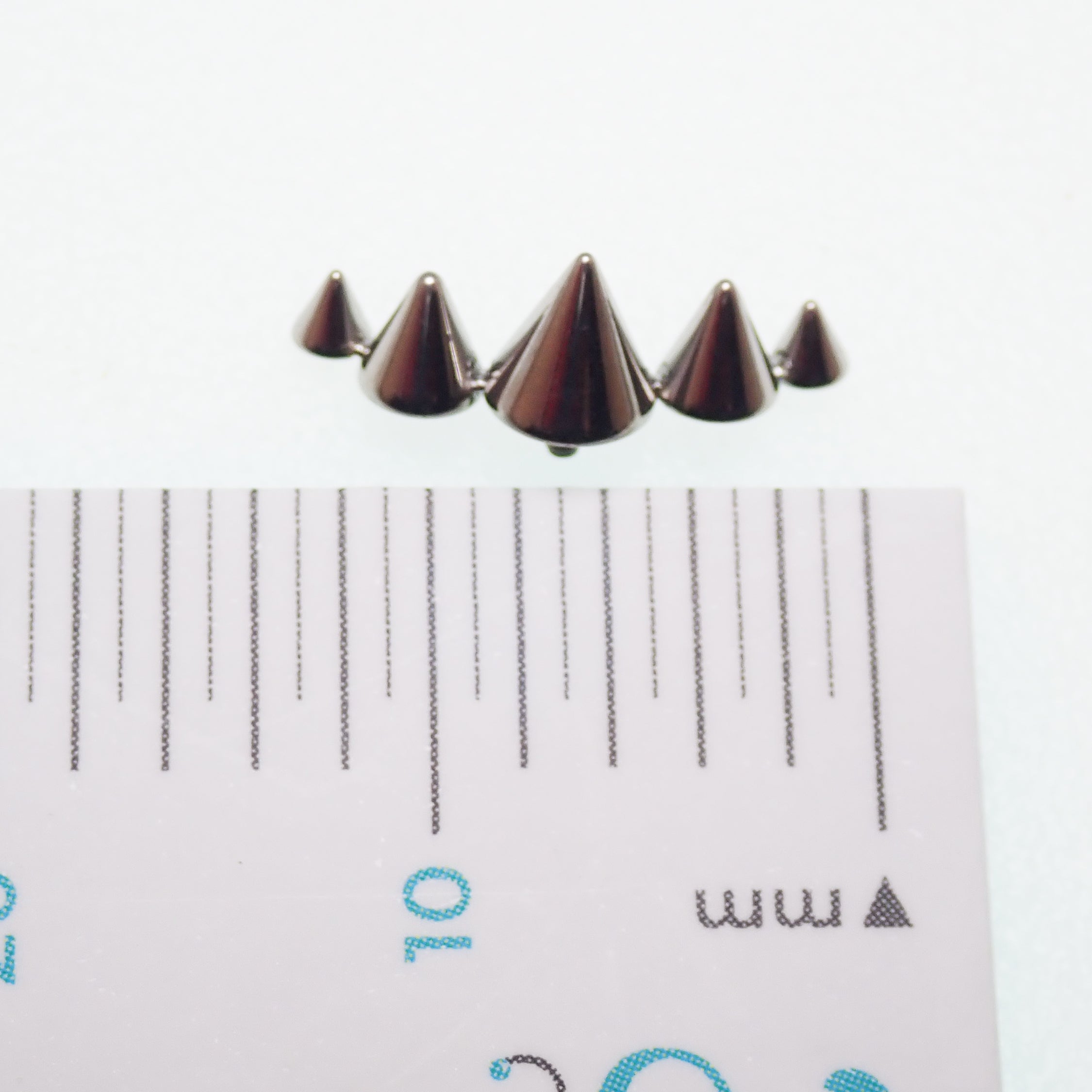 Titanium cone spike curve implant labret earrings, flatback, internally threaded, available in 14g, 16g, and 18g sizes.