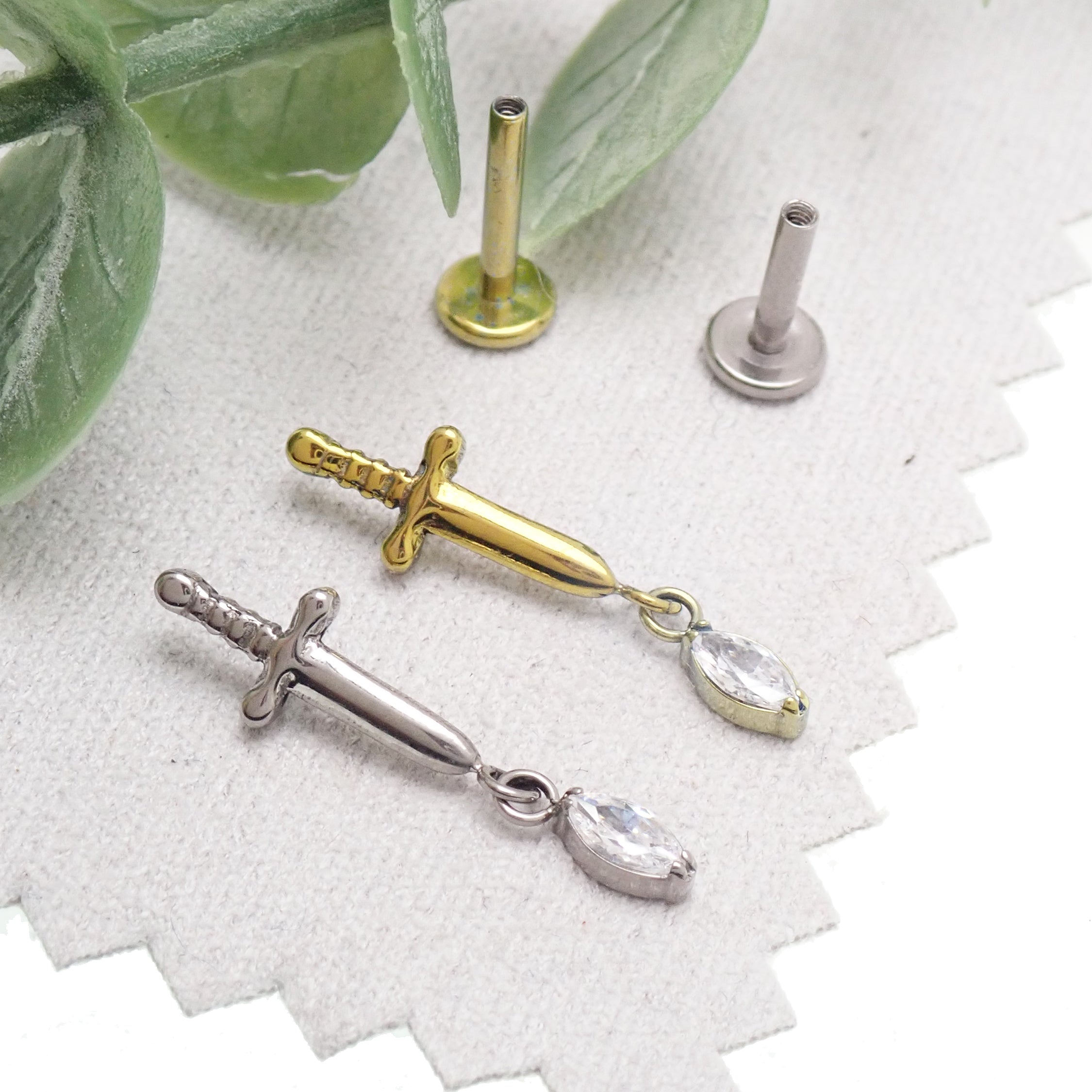 Body Clickers titanium dagger flatback earrings in 14g, 16g, and 18g with 6mm size, designed for pierced ears.