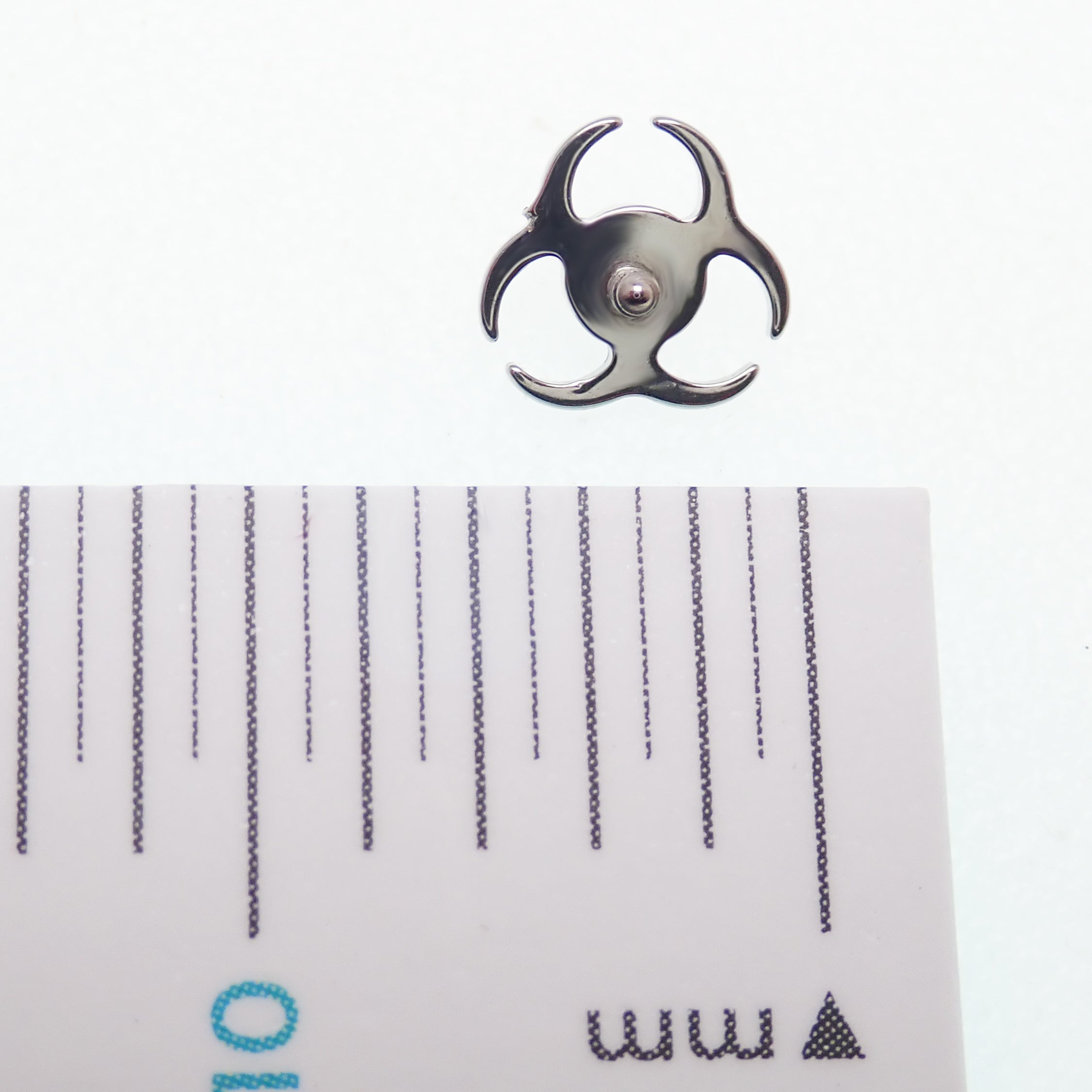 Titanium amethyst biohazard symbol flatback labret piercing earrings in 14g, 16g, and 18g with a sleek, eye-catching design.