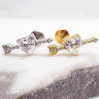 Body Clickers 18g titanium CZ arrow through heart flatback labret piercing earrings, featuring a sleek arrow design and heart motif.