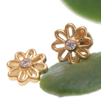 Gold flower implant titanium labret piercing with CZ stone, available in 14g, 16g, and 18g, Body Clickers earrings.