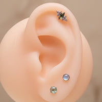 Body Clickers Moss Agate and CZ implant titanium earrings with flatback design in 14g, 16g, and 18g gauges.