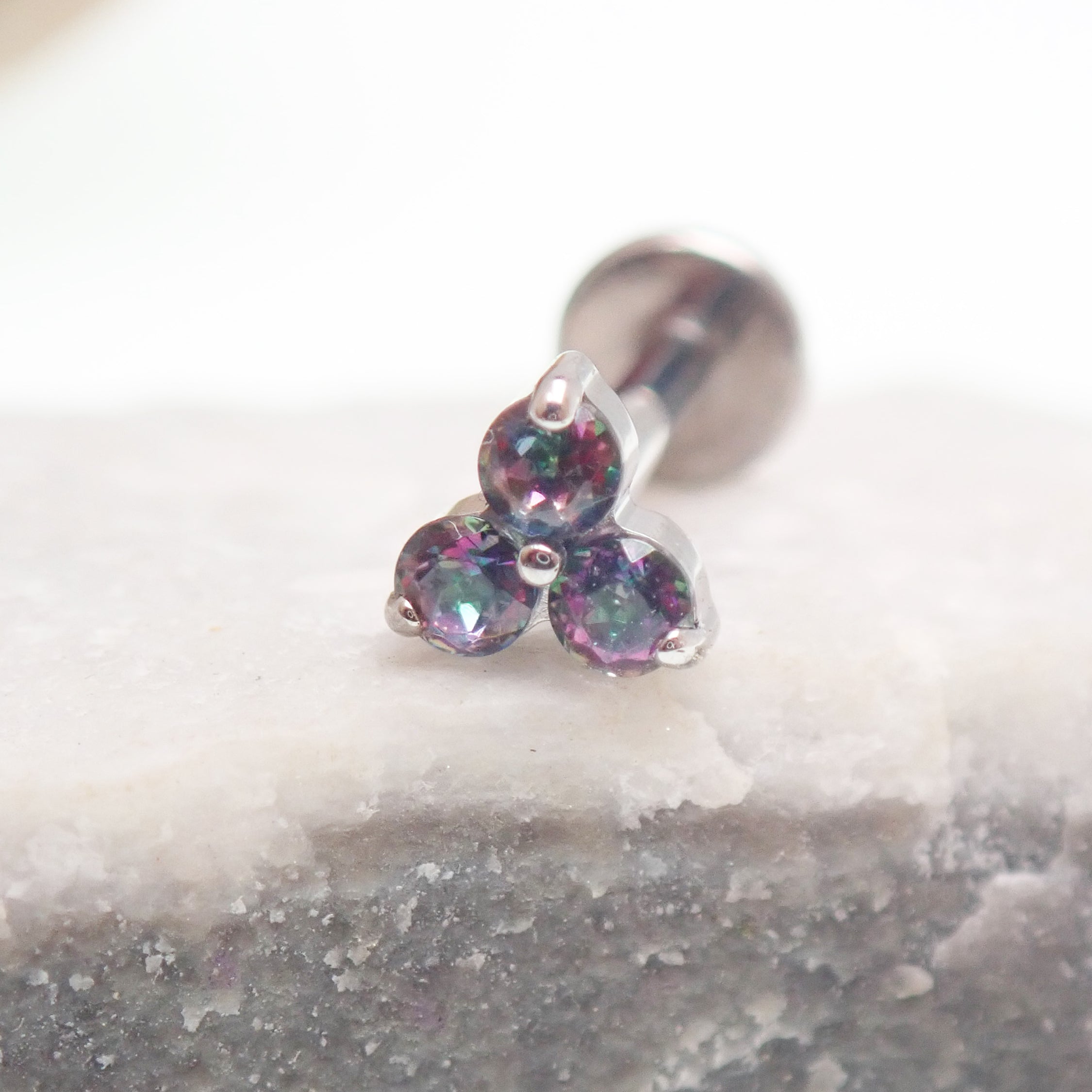Body Clickers earrings with Mystic Topaz natural stone flower design in titanium flatback labret piercing, available in 14g, 16g, and 18g.