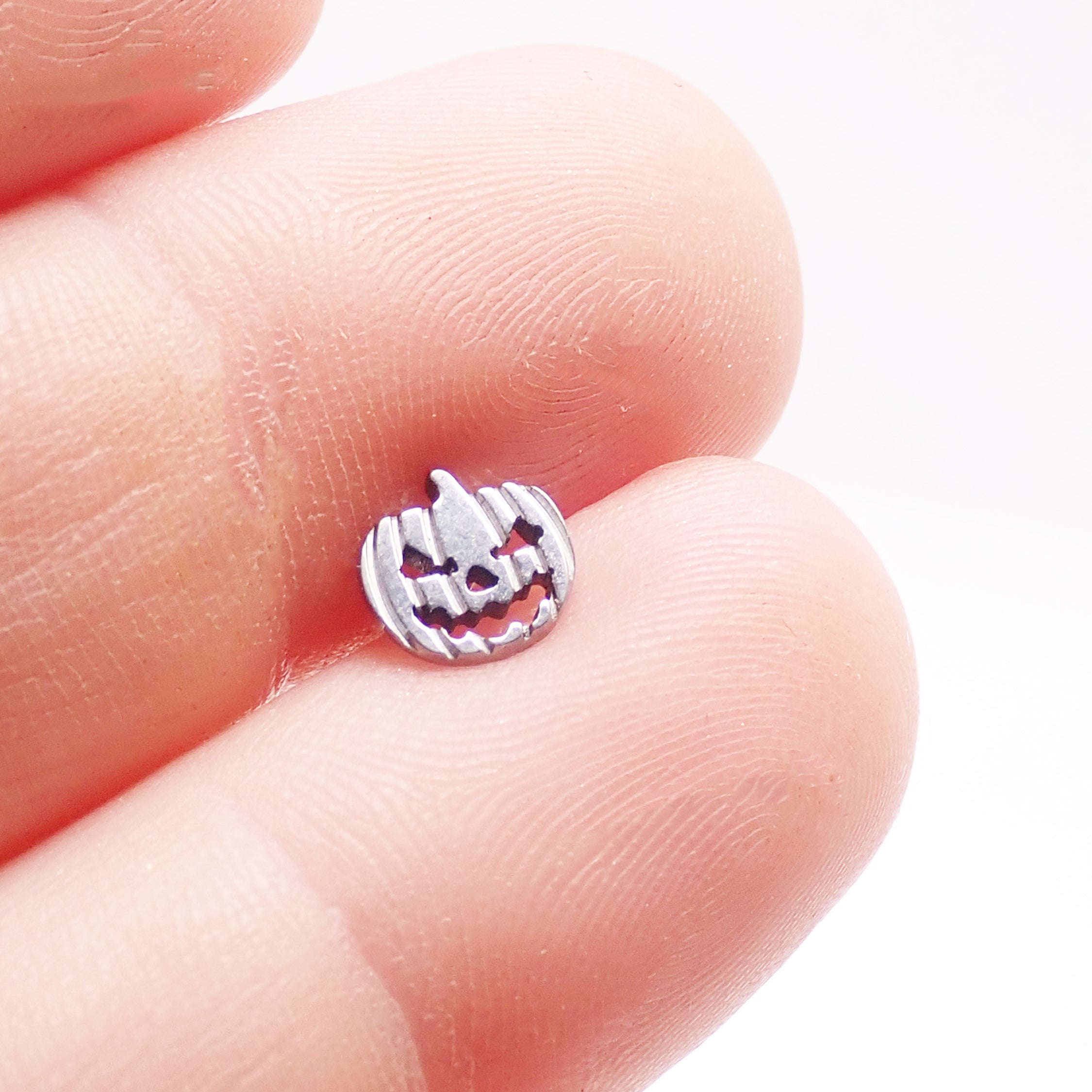 Pumpkin titanium flatback earring by Body Clickers in 18g, 16g, and 14g sizes, featuring a pumpkin design and smooth flatback style.