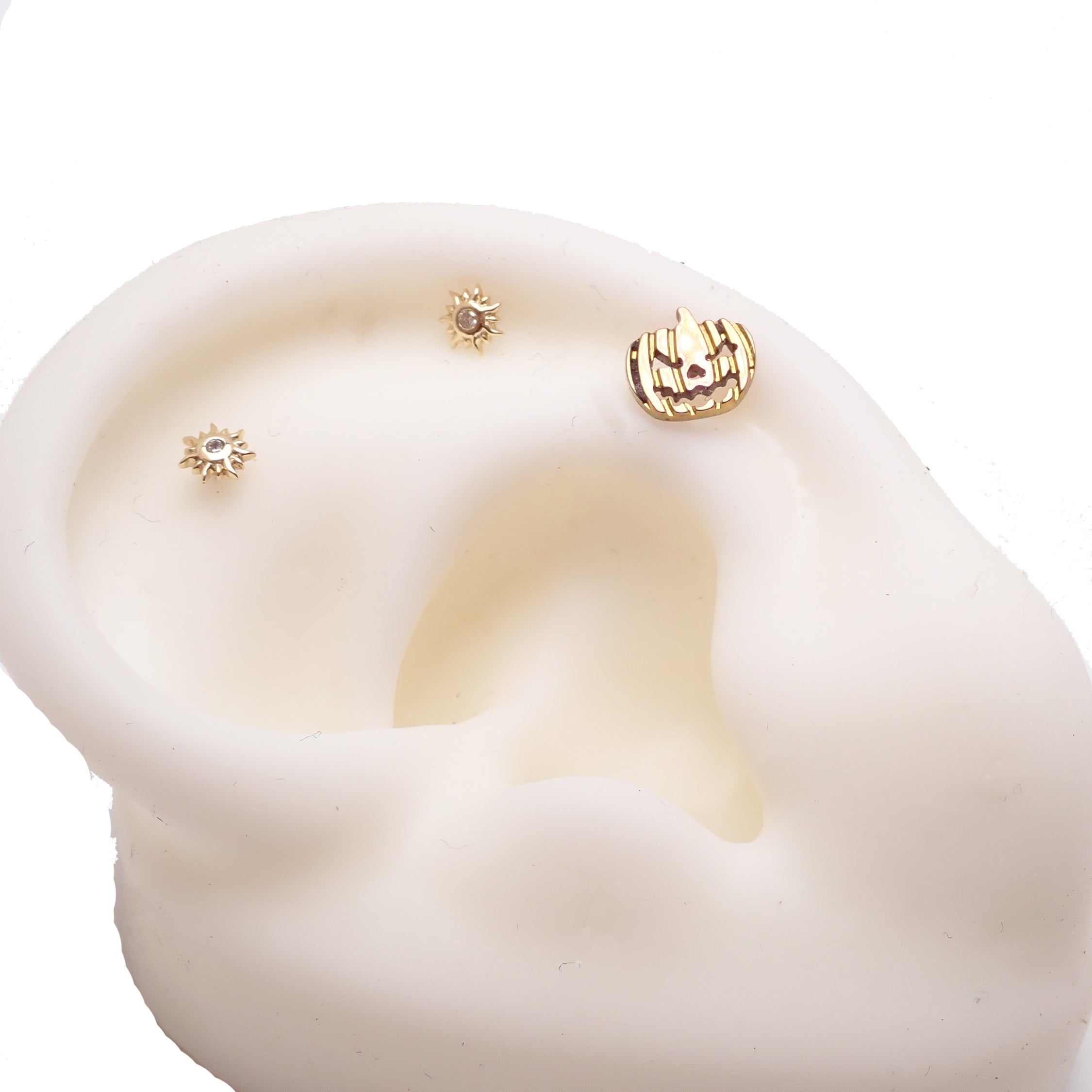 Pumpkin-shaped titanium flatback piercing earrings in 14g, 16g, and 18g from Body Clickers, designed for body jewelry.