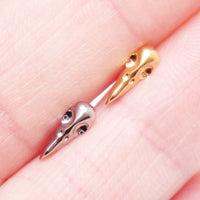 Titanium Raven Skull flatback piercing earrings in 14g, 16g, and 18g with internally threaded design by Body Clickers.