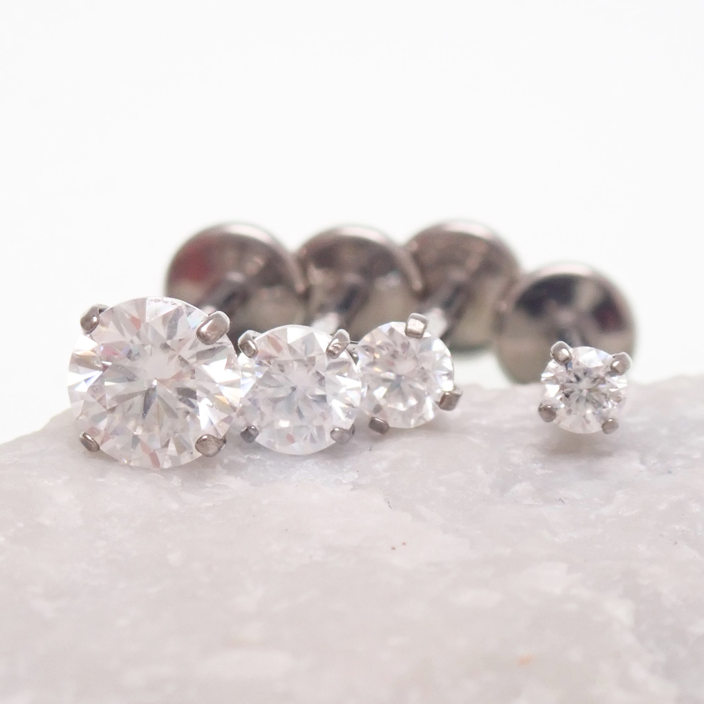 Body Clickers moissanite implant titanium flatback piercing earrings in 18g, 16g, 14g with 0.9mm internal thread, 6mm size.