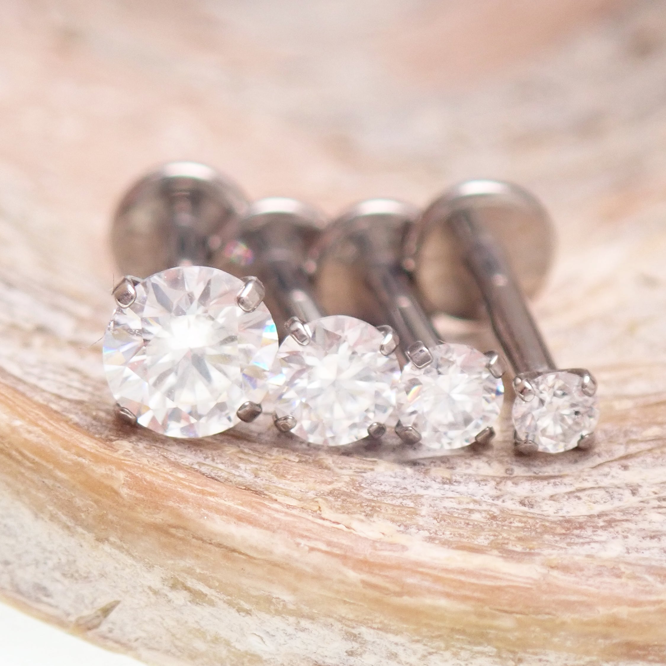 Body Clickers Moissanite implant titanium flatback earrings in 18g, 16g, 14g with 2mm Moissanite stones and 0.9mm thread.