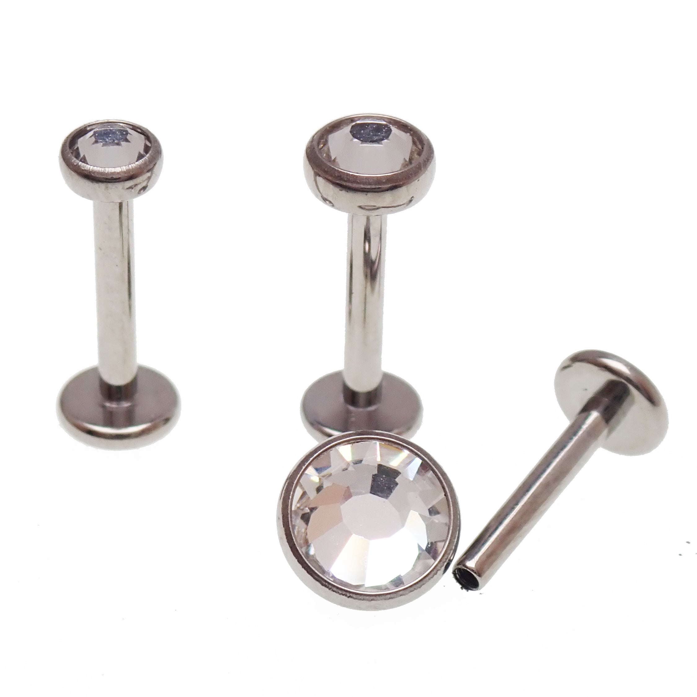 Clear CZ and cerise AB rainbow internally threaded implant titanium flatback earrings in 14g, 16g, and 18g sizes.