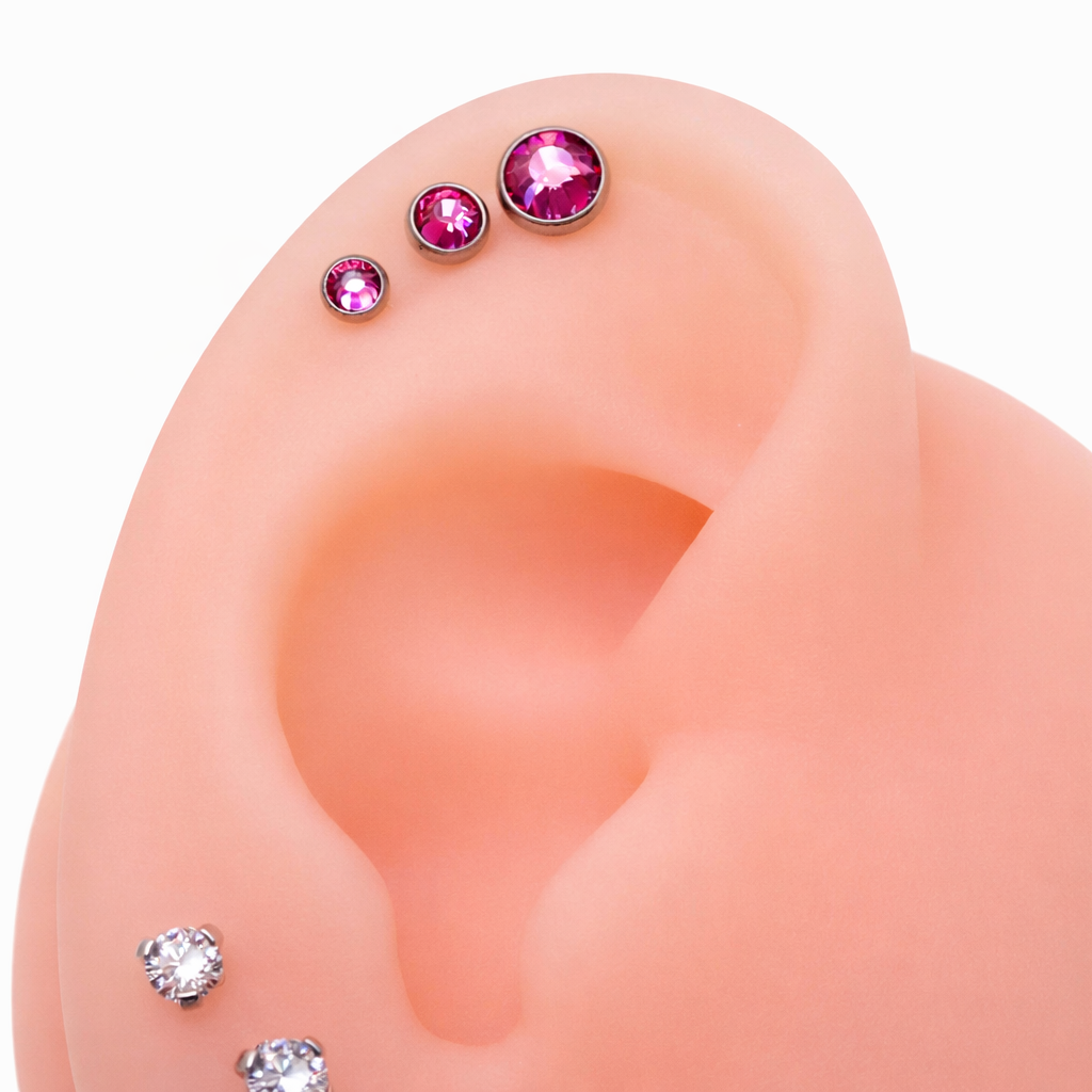 Clear CZ and cerise AB rainbow internally threaded implant titanium flatback earrings in 14g, 16g, and 18g.