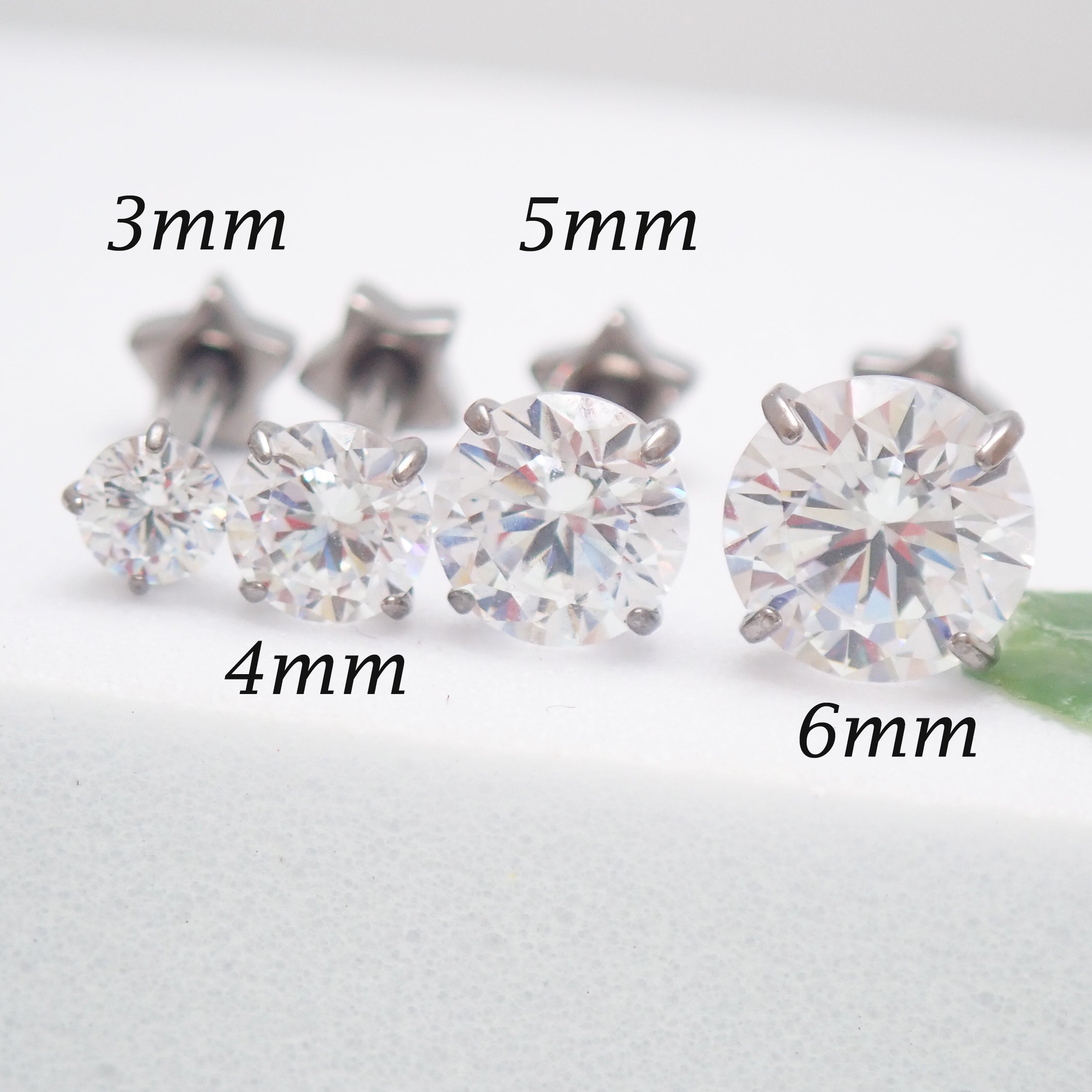 Set of 4 implant-grade titanium star back CZ earrings, externally threaded, 16g, 8mm, designed for piercing jewelry.