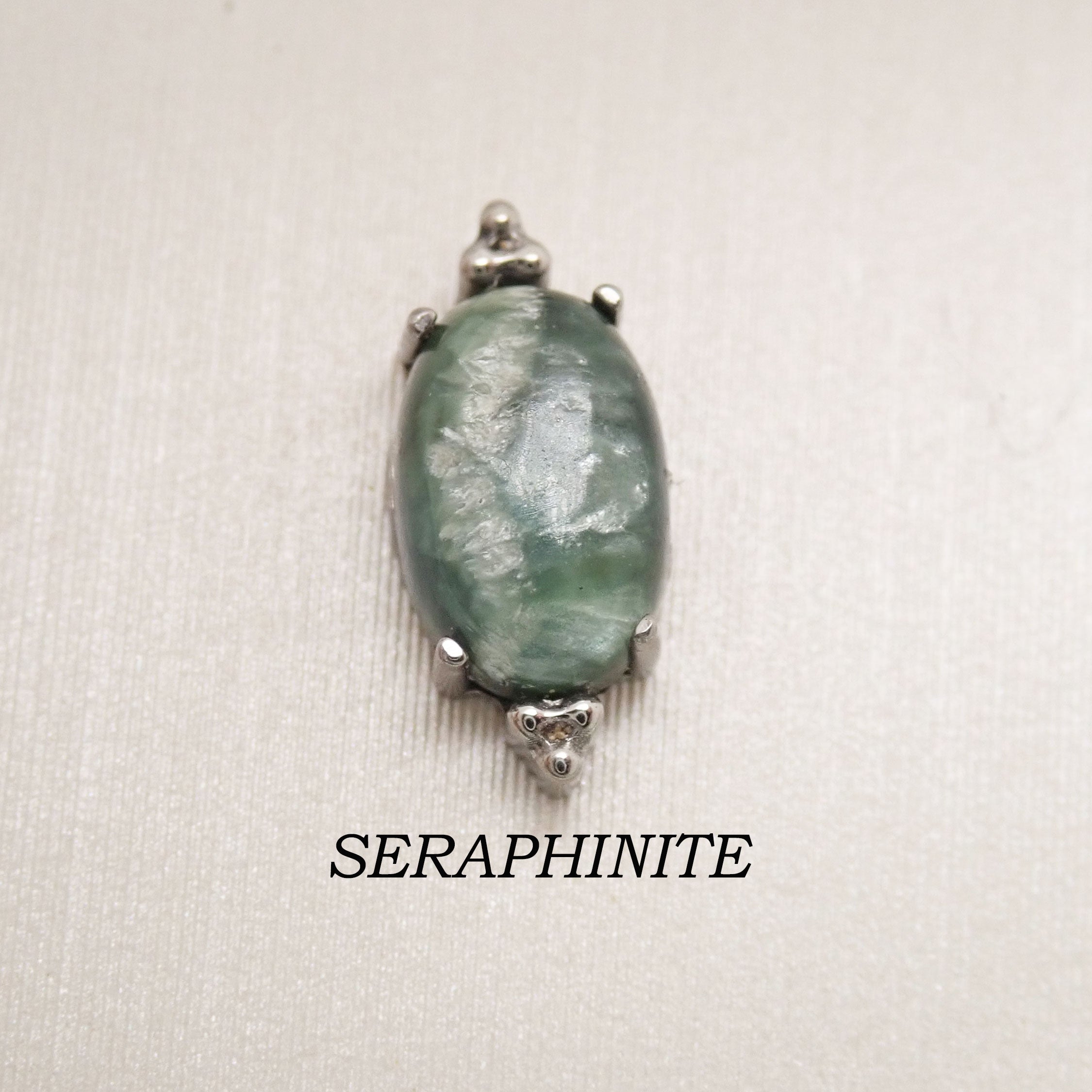 Titanium labret piercing earrings with oval natural seraphinite stone, available in 14g, 16g, and 18g sizes by Body Clickers.