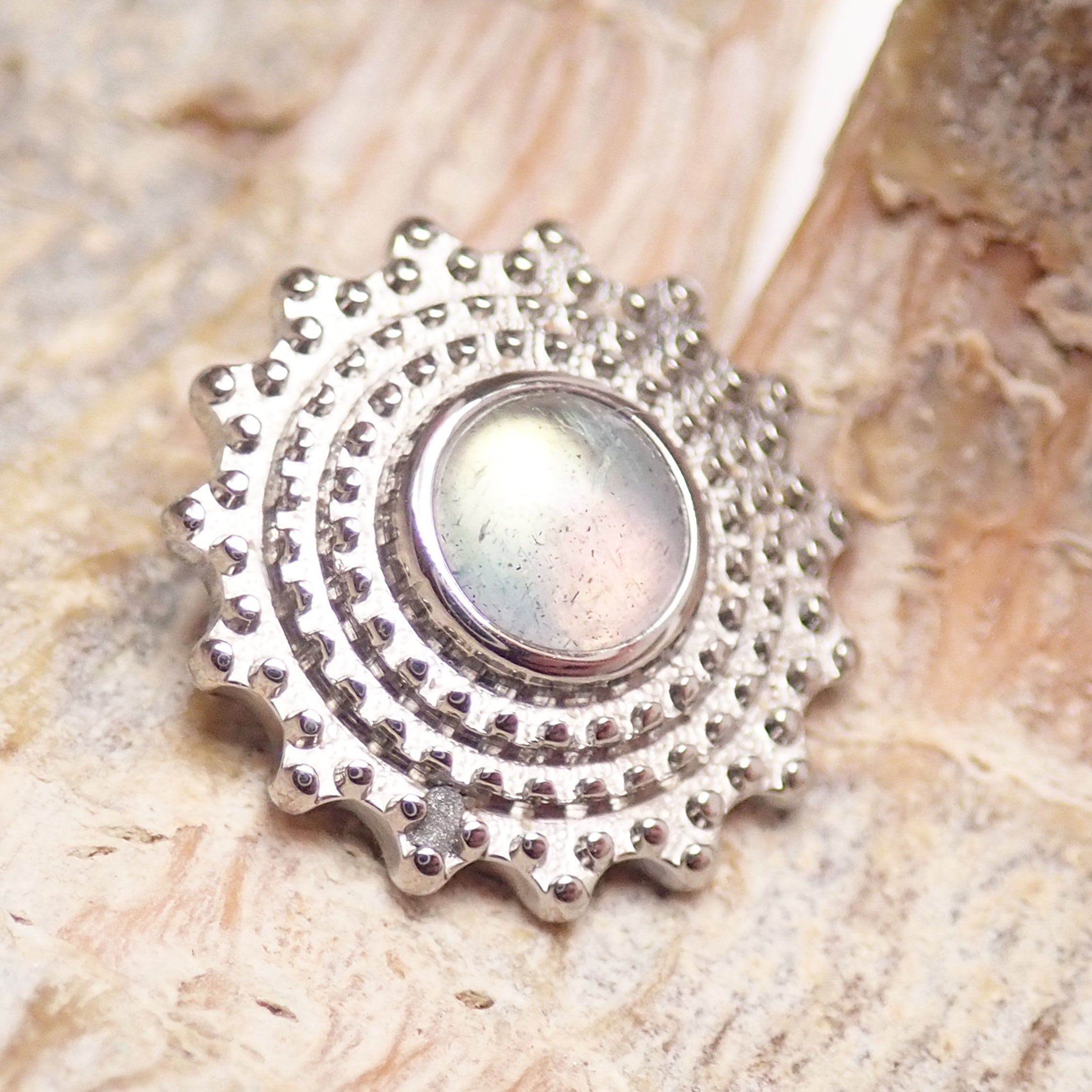 Semi-precious Labradorite Mandala flatback implant in titanium, 6mm size, shown on a body jewelry flatback implant.