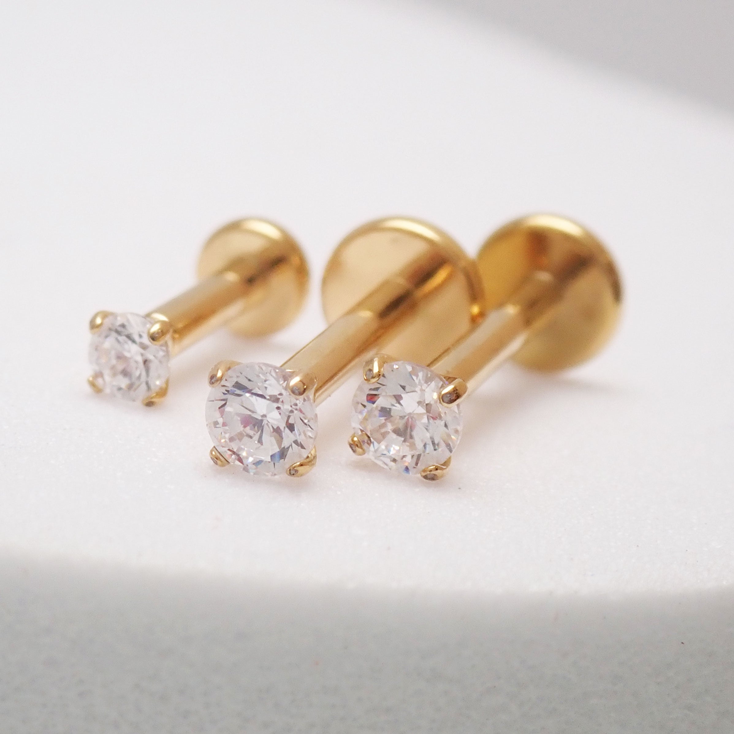 Set of three Body Clickers PVD gold titanium flatback labret studs, 16G internally threaded piercing jewelry.