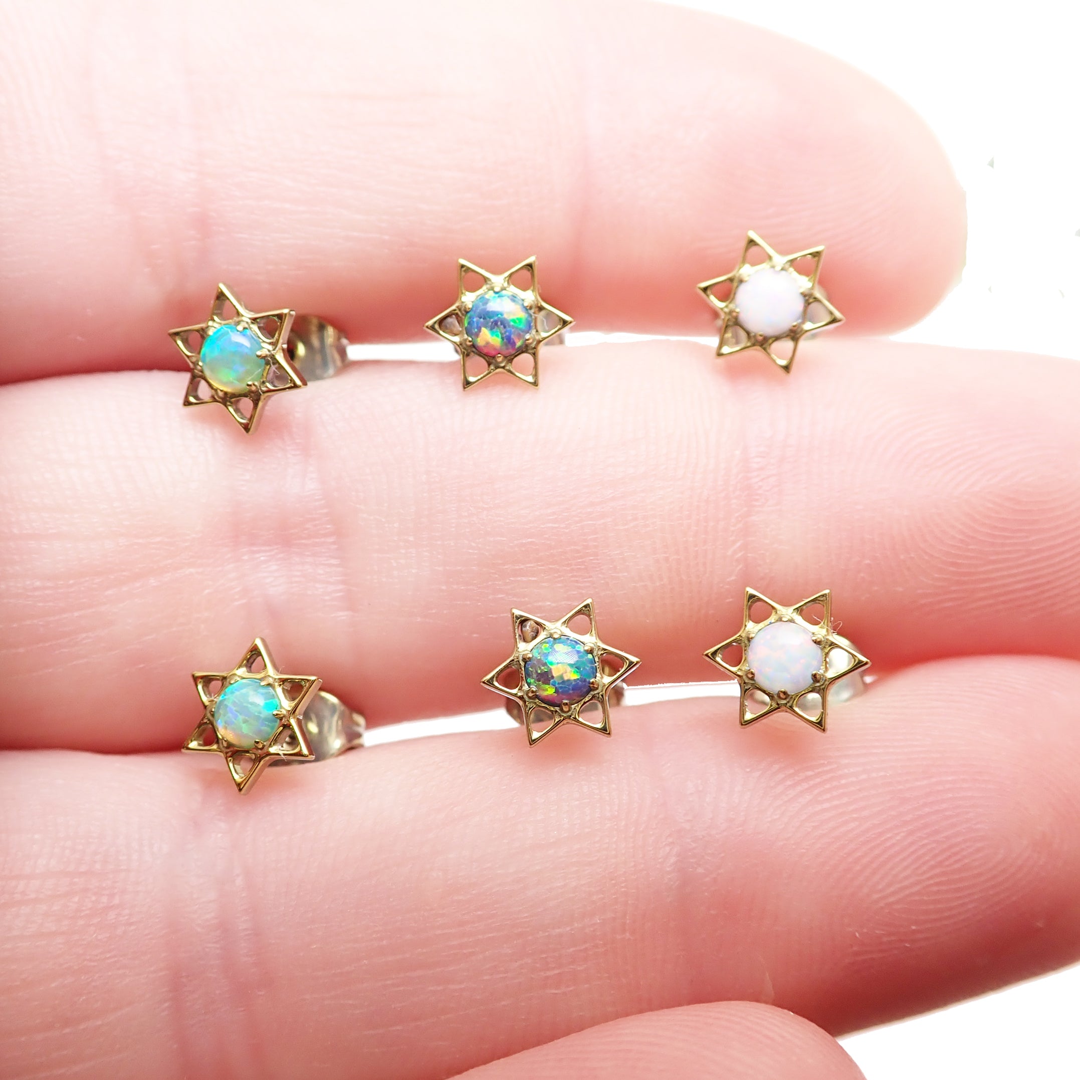 White opal implant titanium star earrings by Body Clickers, 20g, featuring shiny star-shaped design and smooth metal finish.