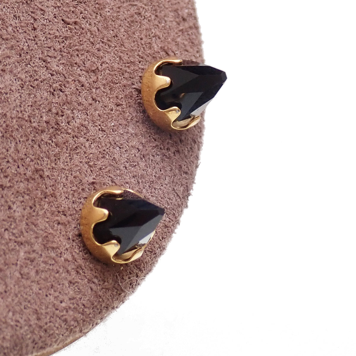 gold onyx earrings n a brown display 