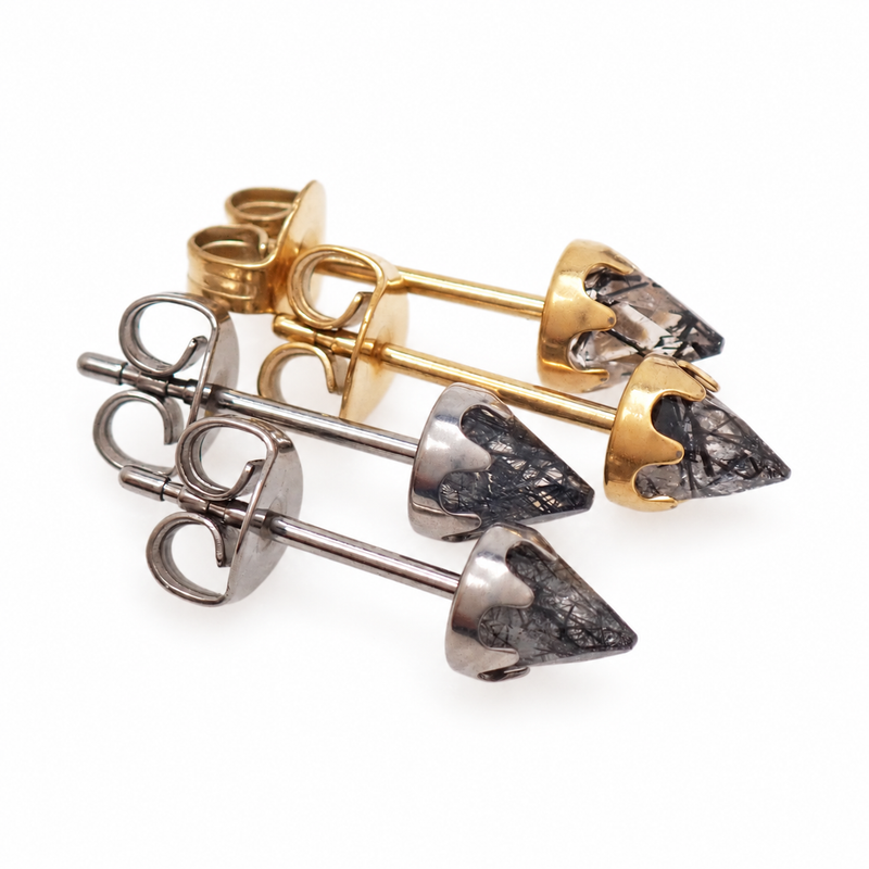 A pair of silver and gold tourmalated quartz earrings on a white background 