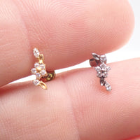 Dainty flower titanium flatback labret piercing earring with 0.9mm threaded post held in hand.