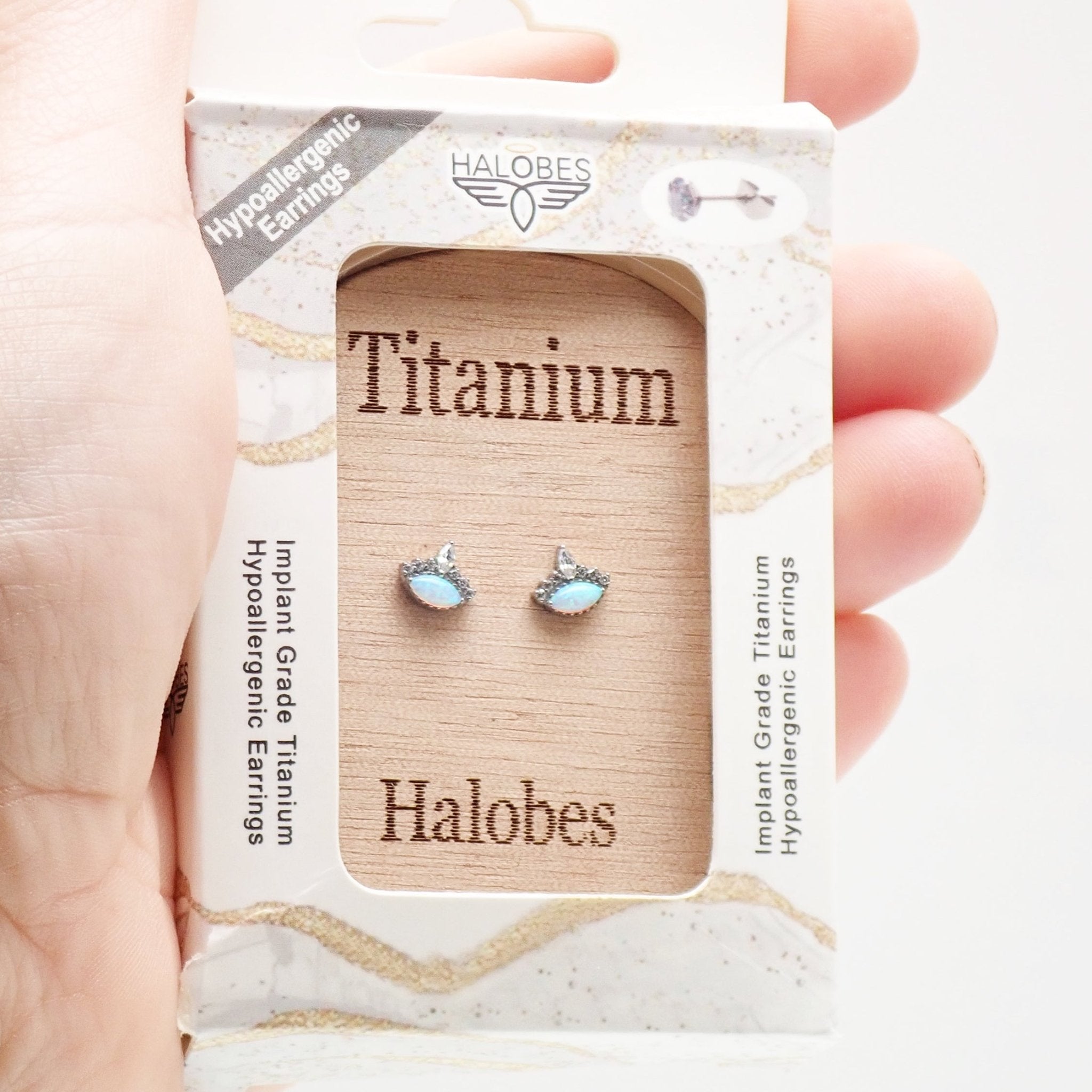 Titanium Opal CZ Crown Earrings by Halobes featuring 20g weight and intricate crown design with sparkling gemstones.