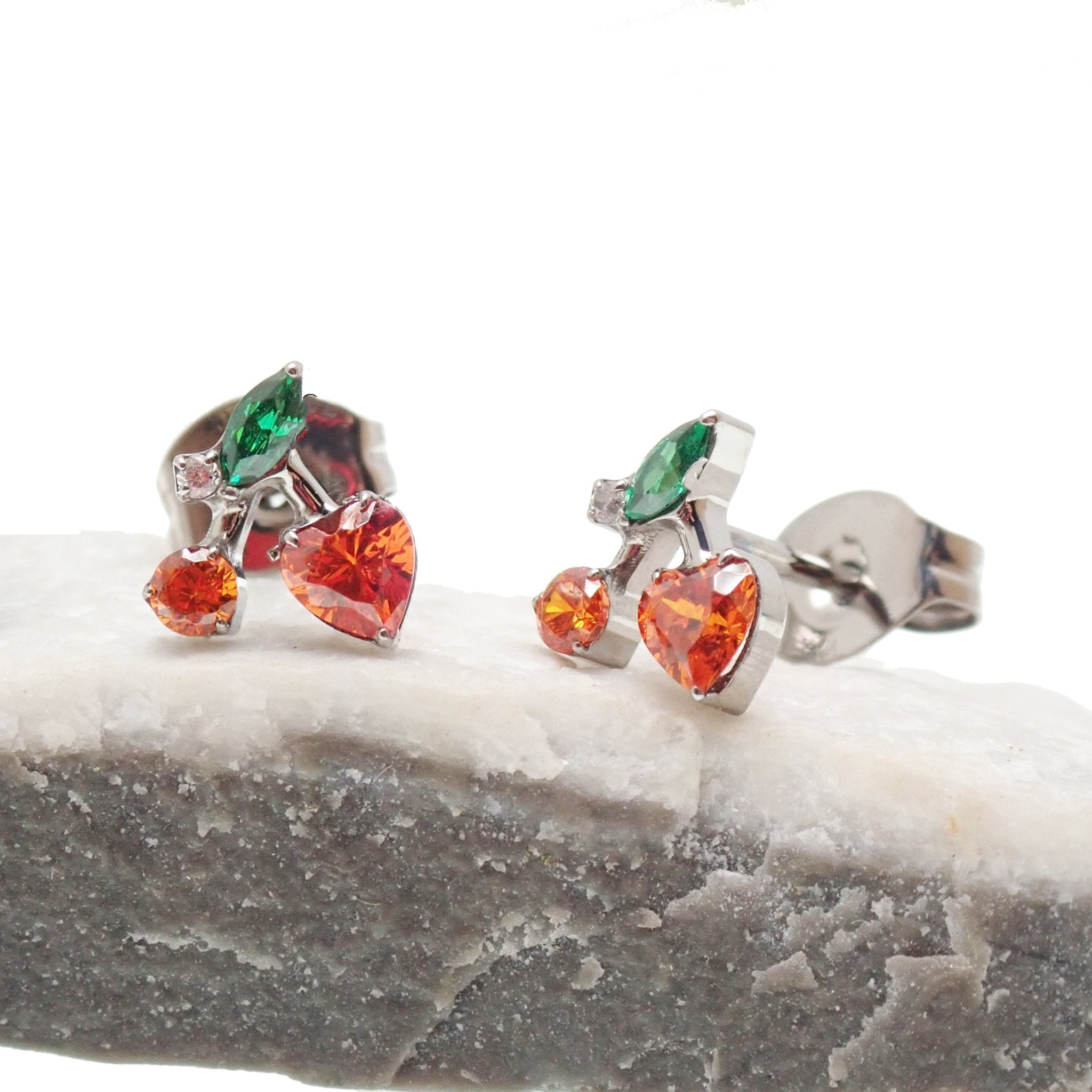 Pair titanium cherry CZ earrings by Halobes featuring vibrant red cherry-shaped stones and sleek silver-tone hooks.