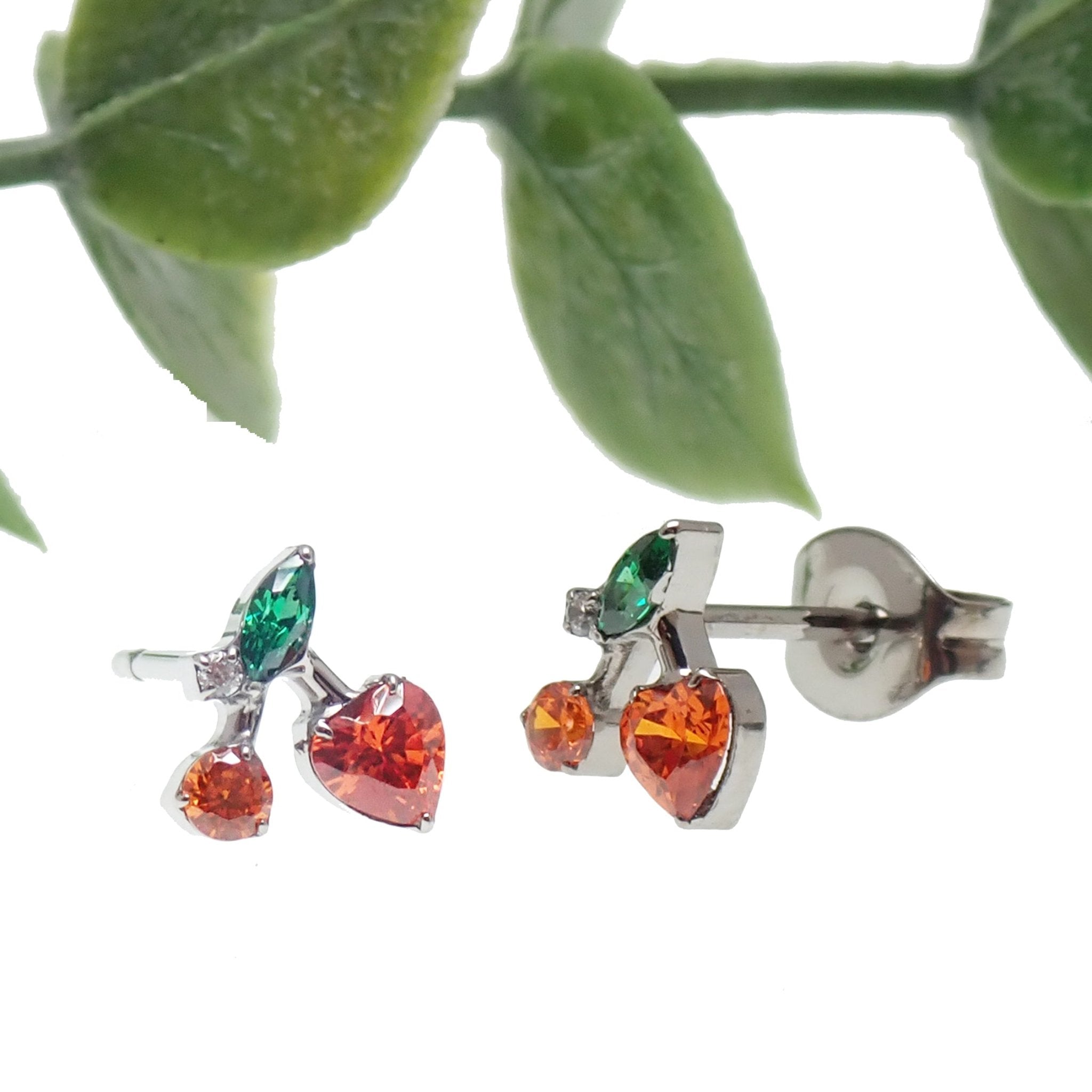 Pair of titanium cherry-shaped CZ earrings from Halobes with sparkling stones and sleek silver finish.