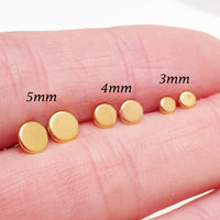 Pair of PVD gold titanium stud earrings featuring flat disc designs in 3mm, 4mm, and 5mm sizes, 20g.