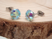 Pair of CZ Mermaid Blue Titanium Earrings by Halobes featuring ocean-inspired design and vibrant blue color.