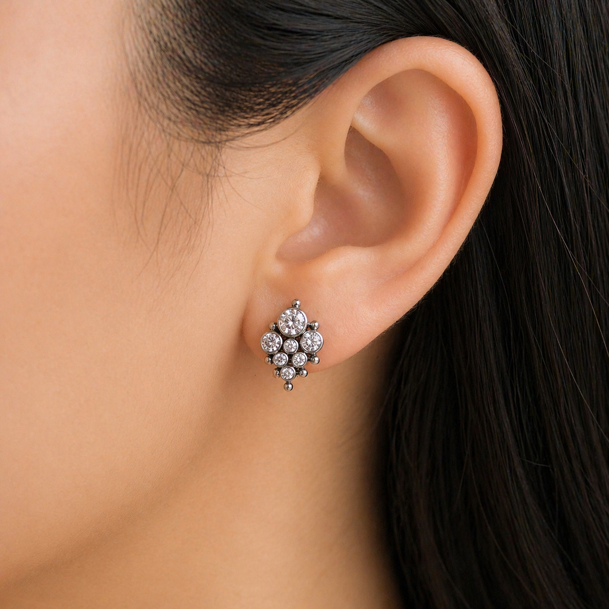 Pair of HALOBES titanium CZ earrings in 20g implant style, featuring shiny cubic zirconia stones on sleek earring designs.