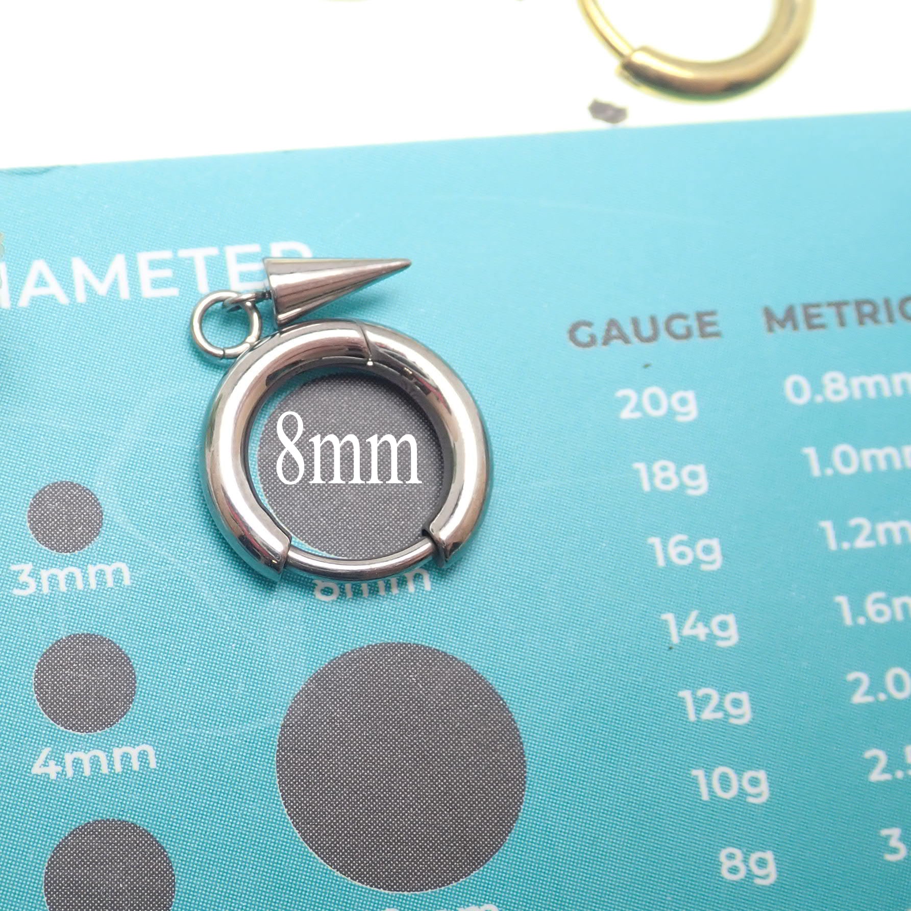 Pair of Halobes titanium implant earrings with drop spike design, 20g gauge, designed for comfortable ear piercing.