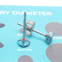 Turquoise 4mm claw set titanium stud earrings by Halobes, featuring sleek, minimalist design in a pair of elegant earrings.