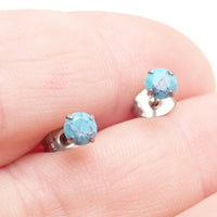 Pair of turquoise 4mm claw set titanium stud earrings by Halobes, featuring a sleek, minimalist design for everyday wear.