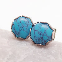 Pair of turquoise 6mm titanium stud earrings by Halobes, lightweight 20g earrings featuring vibrant turquoise stones and sleek design.