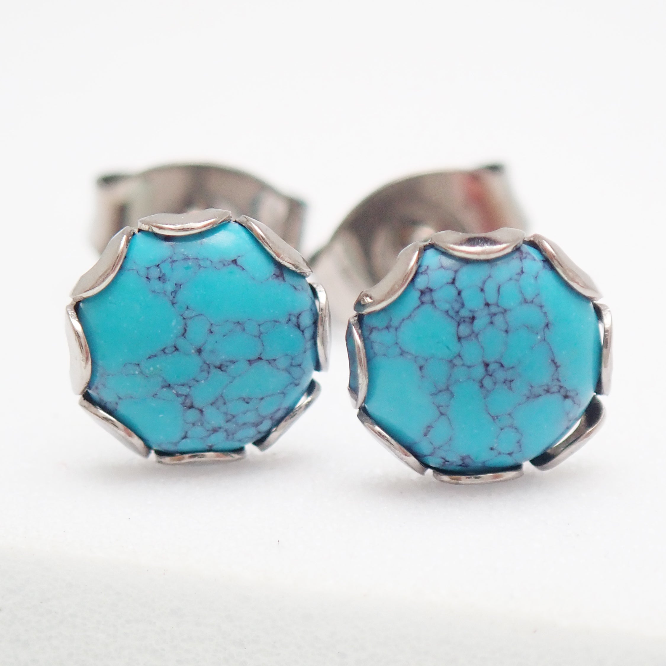 Pair of turquoise 6mm titanium stud earrings by Halobes, featuring a sleek design and 20g weight, perfect for everyday wear.
