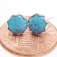 Pair of turquoise 6mm titanium stud earrings by Halobes, showing the smooth, round turquoise stones set in titanium posts.