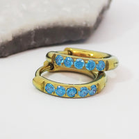Titanium Gold hoop earrings with blue CZ