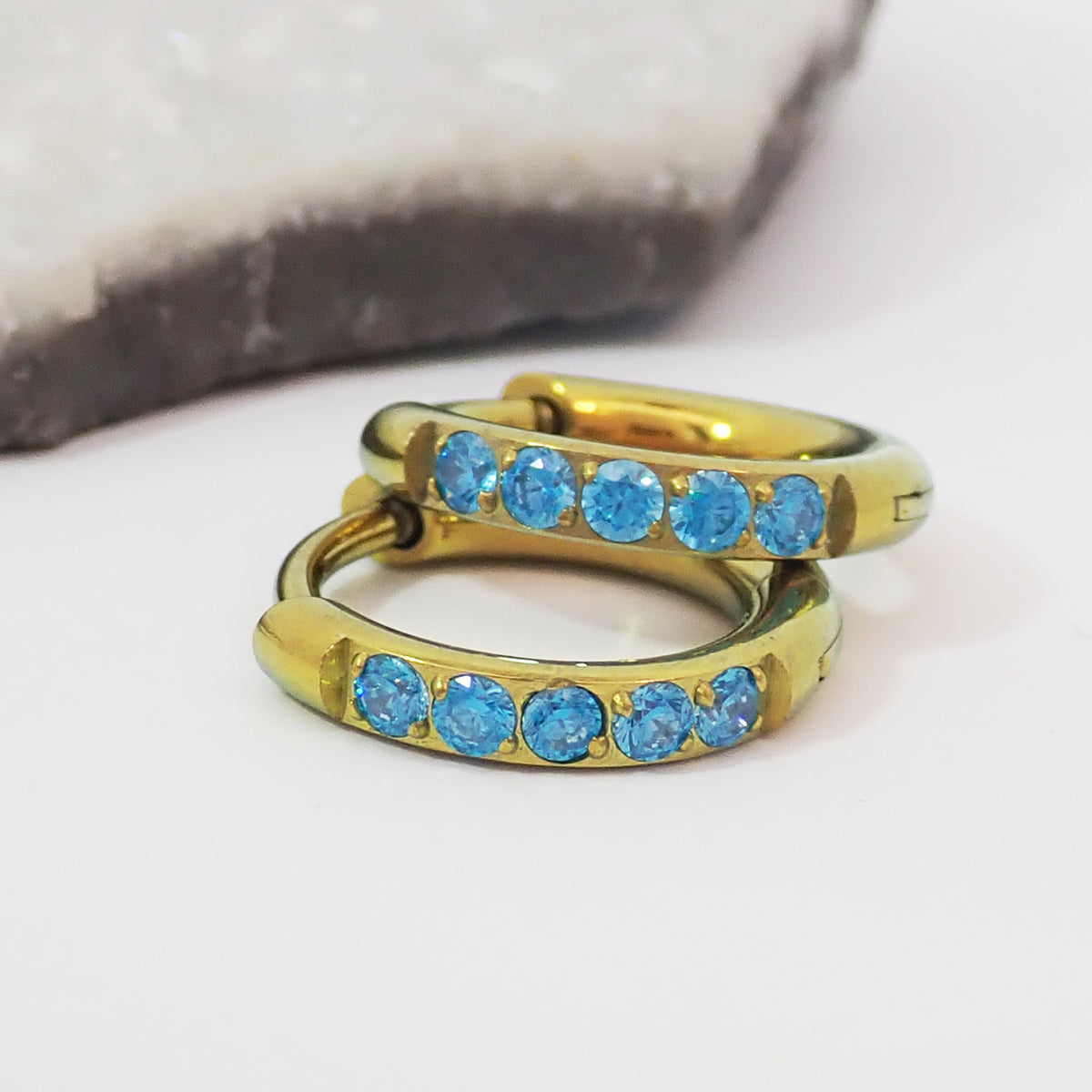 Titanium Gold hoop earrings with blue CZ