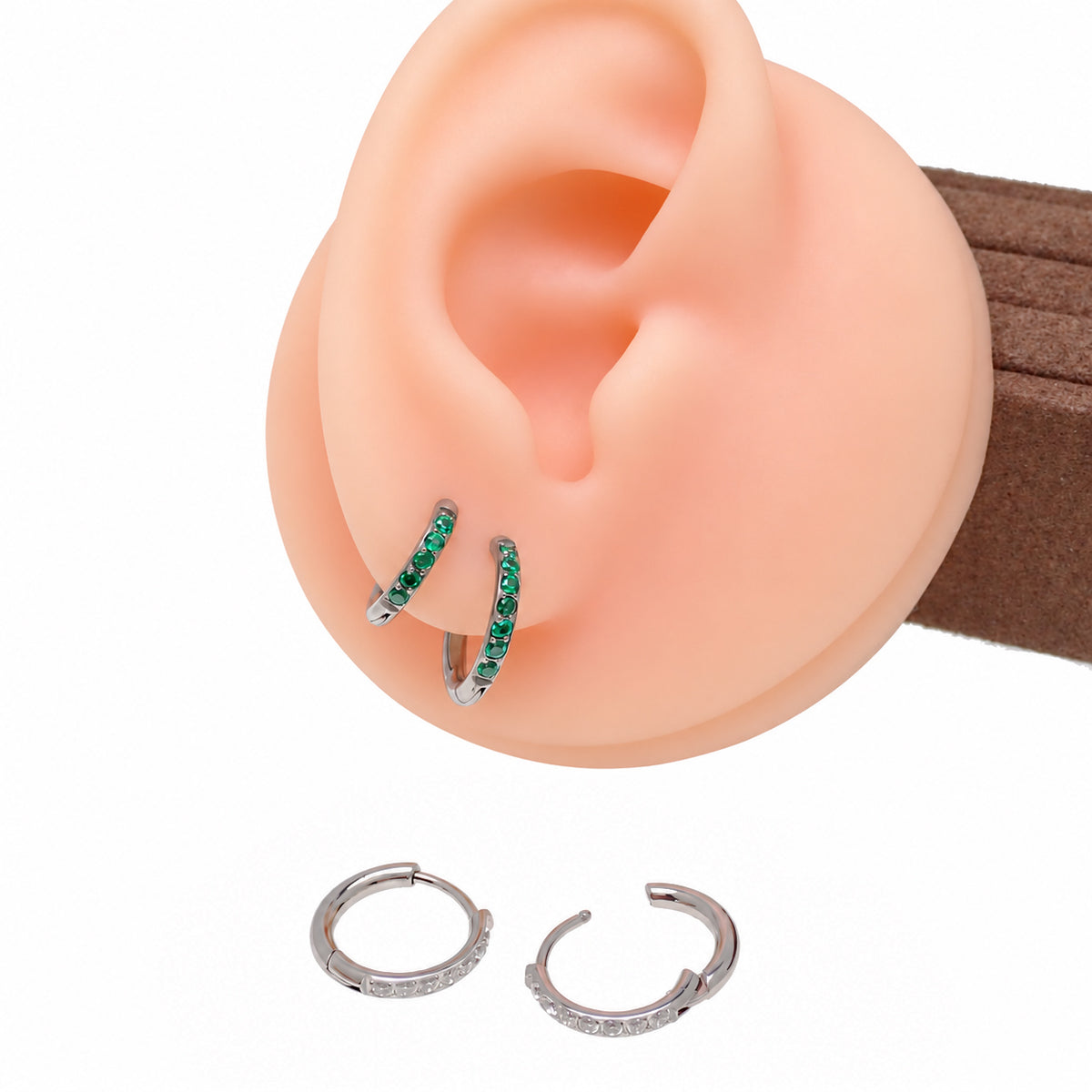 Implant titanium huggie earrings on a silicone model 