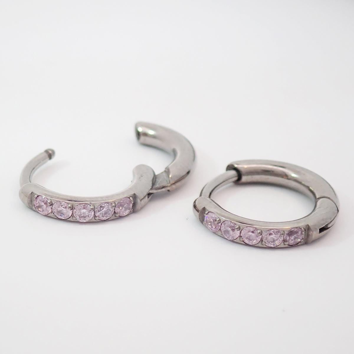 Titanium hinged clicker earrings with pink CZ